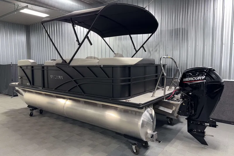 Slide: The Image of 2026 Sylvan Mirage 8520 Cruise PTS Tritoon with Mercury engine in a showroom. - 23