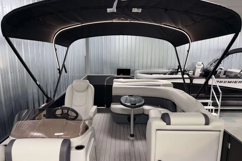 Slide: The Image of 2026 Sylvan Mirage 8520 Cruise PTS Tritoon with spacious seating and canopy in showroom. - 25