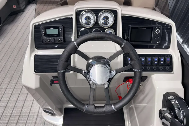 Slide: The Image of 2026 Sylvan Mirage 8520 Cruise PTS Tritoon dashboard with steering wheel and control panel. - 8