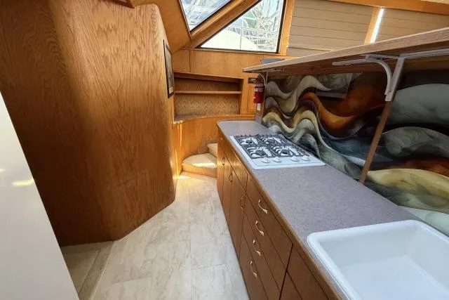 Slide: The Image of Interior of 1986 Fexas Custom 57 yacht with modern kitchen and artistic backsplash. - 15