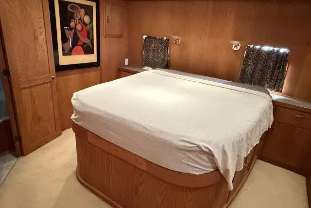Slide: The Image of Luxurious bedroom in 1986 Fexas Custom 57 yacht with wood paneling and modern art. - 17