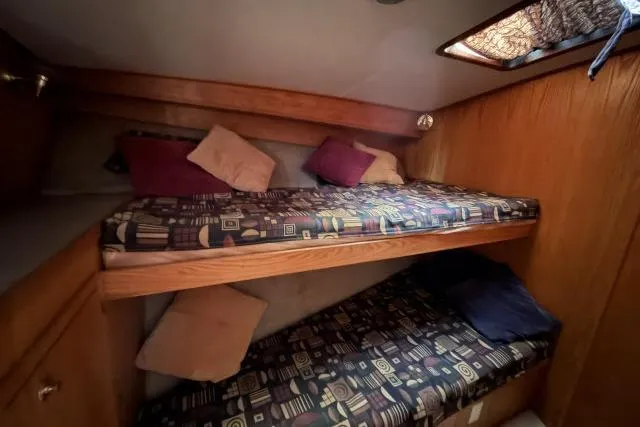 Slide: The Image of Bunk beds in 1986 Fexas Custom 57 yacht cabin with patterned bedding and pillows. - 22