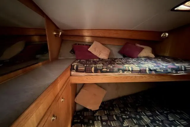 Slide: The Image of Cozy cabin interior of 1986 Fexas Custom 57 yacht with bunk beds and wooden cabinetry. - 23