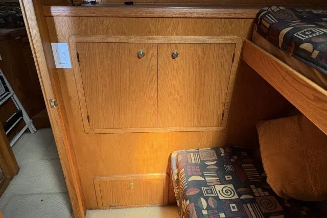 Slide: The Image of 1986 Fexas Custom 57 interior with wooden cabinetry and patterned upholstery. - 25