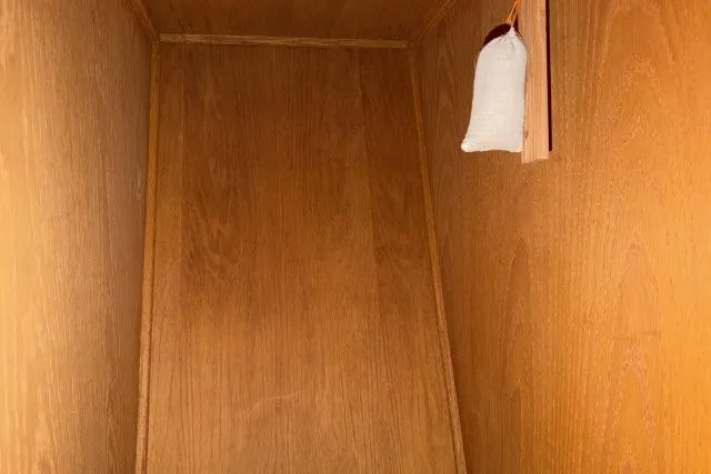 Slide: The Image of Wooden interior of a 1986 Fexas Custom 57 boat with a hanging sachet. - 30