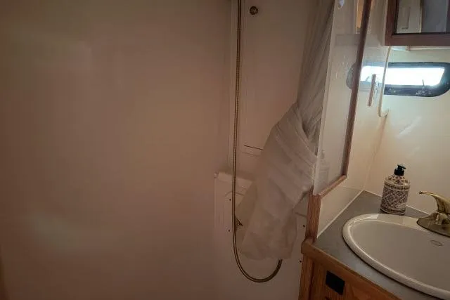 Slide: The Image of Bathroom interior of 1986 Fexas Custom 57 yacht with sink and shower area. - 31