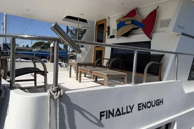 Slide: The Image of 1986 Fexas Custom 57 yacht deck with seating, named "Finally Enough." - 33
