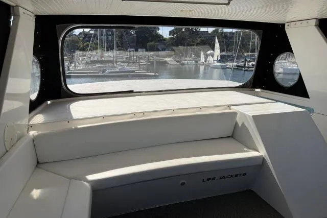 Slide: The Image of Interior view of 1986 Fexas Custom 57 yacht with marina backdrop. - 34