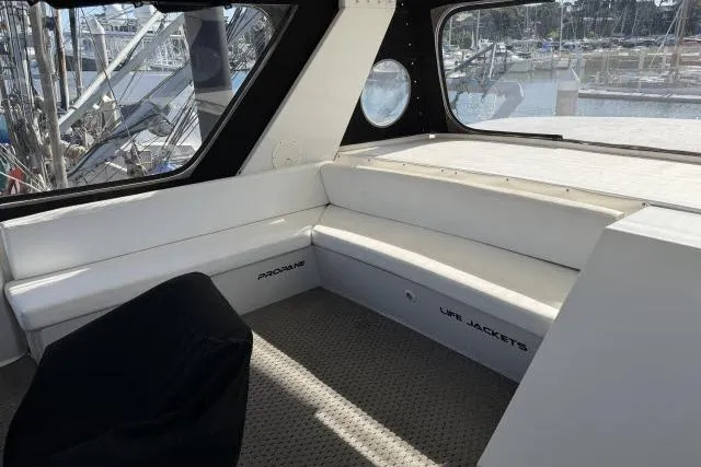 Slide: The Image of Interior of 1986 Fexas Custom 57 yacht with white seating and storage compartments. - 35