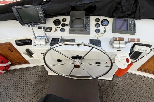 Slide: The Image of 1986 Fexas Custom 57 boat helm with steering wheel and navigation instruments. - 36