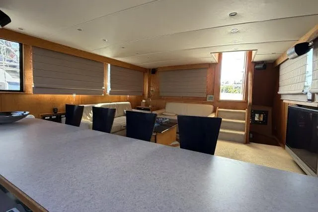 Slide: The Image of Luxurious interior of 1986 Fexas Custom 57 yacht with modern furnishings and ample natural light. - 4