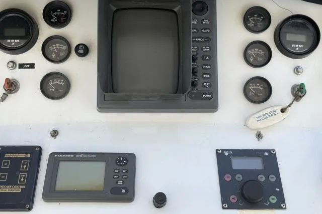 Slide: The Image of Control panel of a 1986 Fexas Custom 57 boat with gauges and navigation equipment. - 40