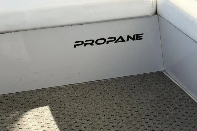 Slide: The Image of 1986 Fexas Custom 57 boat interior with "Propane" label on cushioned seating area. - 43