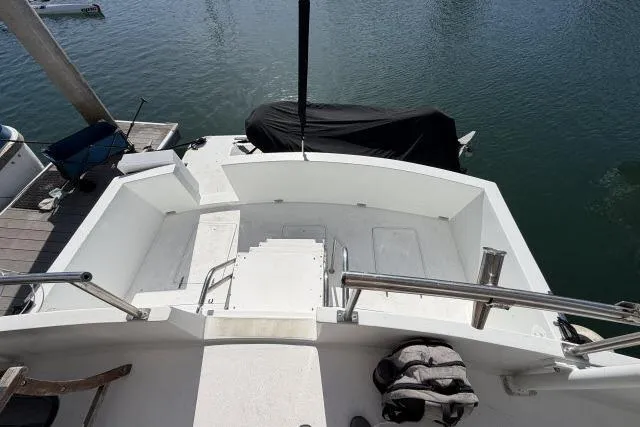 Slide: The Image of 1986 Fexas Custom 57 yacht stern view with seating, docked at marina. - 45