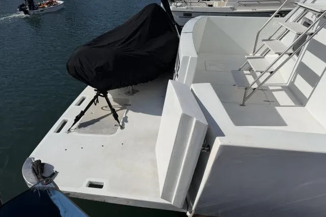 Slide: The Image of 1986 Fexas Custom 57 yacht stern with covered equipment and ladder. - 48