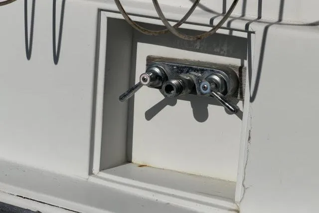 Slide: The Image of Control panel on a 1986 Fexas Custom 57 boat, featuring dual levers and cables. - 49