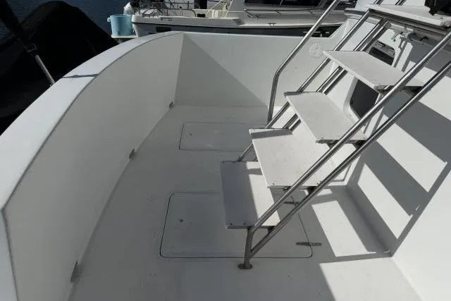 Slide: The Image of White deck of 1986 Fexas Custom 57 boat with metal stairs. - 51