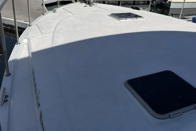 Slide: The Image of 1986 Fexas Custom 57 yacht deck with hatch, docked at marina. - 54