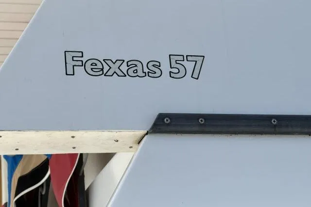 Slide: The Image of 1986 Fexas Custom 57 boat detail with model name on hull. - 57