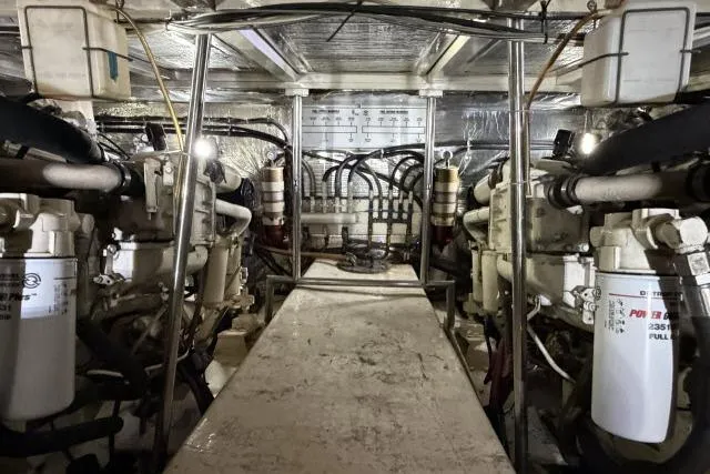 Slide: The Image of Engine room of 1986 Fexas Custom 57 yacht with visible machinery and piping. - 59