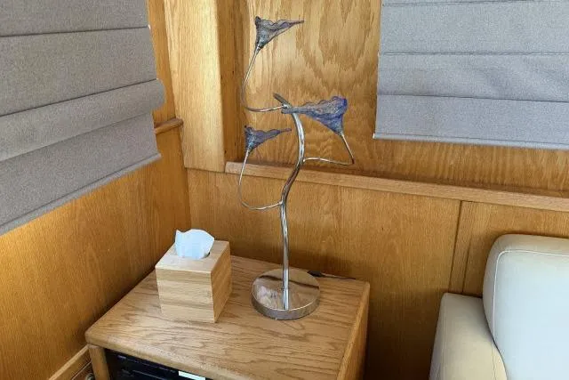 Slide: The Image of Wooden interior of 1986 Fexas Custom 57 with modern sculpture and tissue box on table. - 6