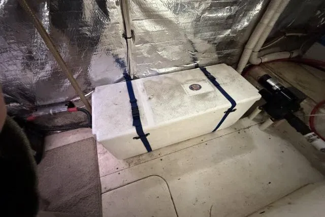 Slide: The Image of Engine room of 1986 Fexas Custom 57 yacht with secured equipment and insulation. - 65