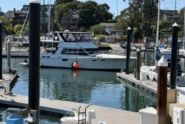 Slide: The Image of 1986 Fexas Custom 57 yacht docked in a marina with surrounding boats. - 68