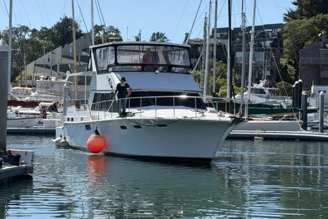 Slide: The Image of 1986 Fexas Custom 57 yacht docked in a marina with people on board. - 69