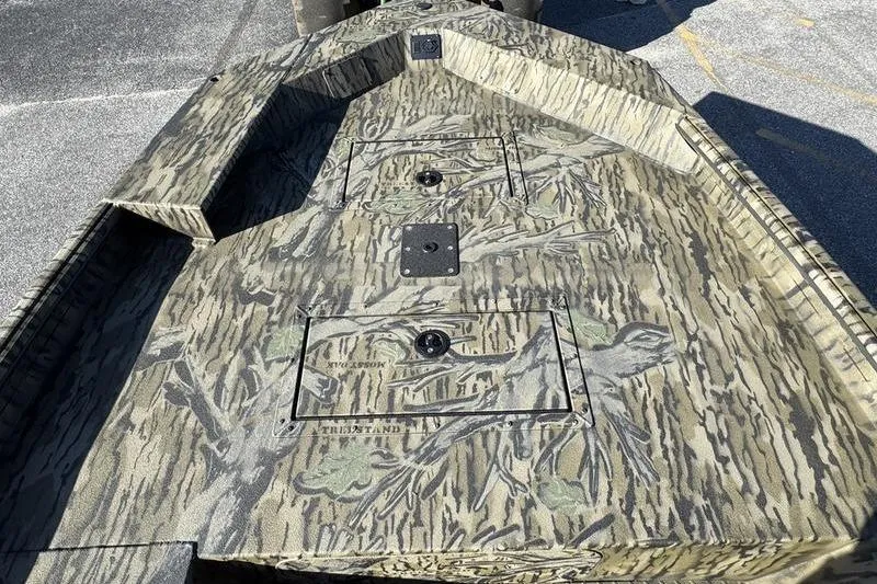 Slide: The Image of 2026 SeaArk 1960 Slayer Pro boat with camouflage design on deck. - 10