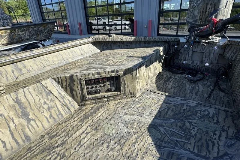 Slide: The Image of 2026 SeaArk 1960 Slayer Pro boat interior with camouflage design and control panel. - 5