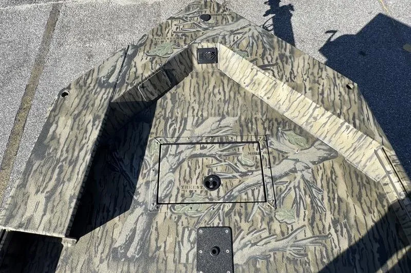 Slide: The Image of 2026 SeaArk 1960 Slayer Pro boat with camouflage pattern on deck. - 7