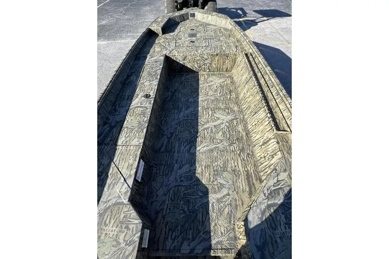 Slide: The Image of 2026 SeaArk 1960 Slayer Pro boat interior with camouflage design, showcasing spacious layout. - 9