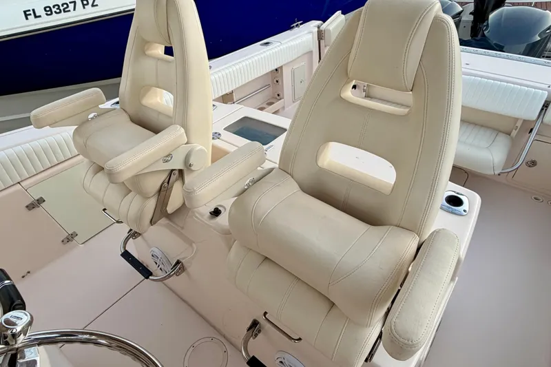 Slide: The Image of Luxury seating on a 2013 Grady-White Canyon 306 boat, featuring plush beige captain chairs. - 12