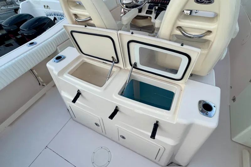 Slide: The Image of 2013 Grady-White Canyon 306 boat with open storage compartments and seating area. - 13