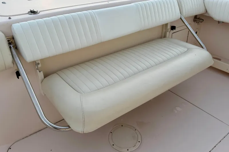 Slide: The Image of 2013 Grady-White Canyon 306 boat seat, white upholstery, foldable design. - 15