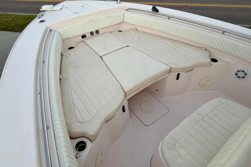 Slide: The Image of 2013 Grady-White Canyon 306 boat interior with cushioned seating and storage compartments. - 16