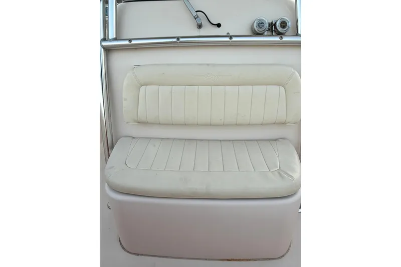 Slide: The Image of 2013 Grady-White Canyon 306 boat seat with white cushioned upholstery. - 17