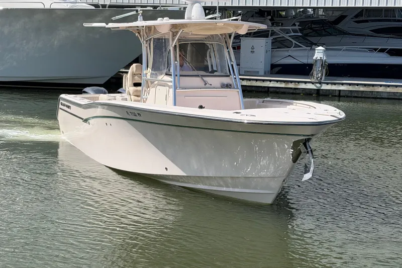 Slide: The Image of 2013 Grady-White Canyon 306 boat docked in marina, side view. - 2
