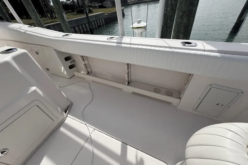Slide: The Image of 2013 Grady-White Canyon 306 boat interior with white seating and storage compartments. - 20