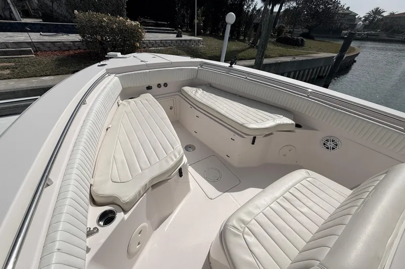 Slide: The Image of 2013 Grady-White Canyon 306 boat interior with cushioned seating and sleek design. - 22