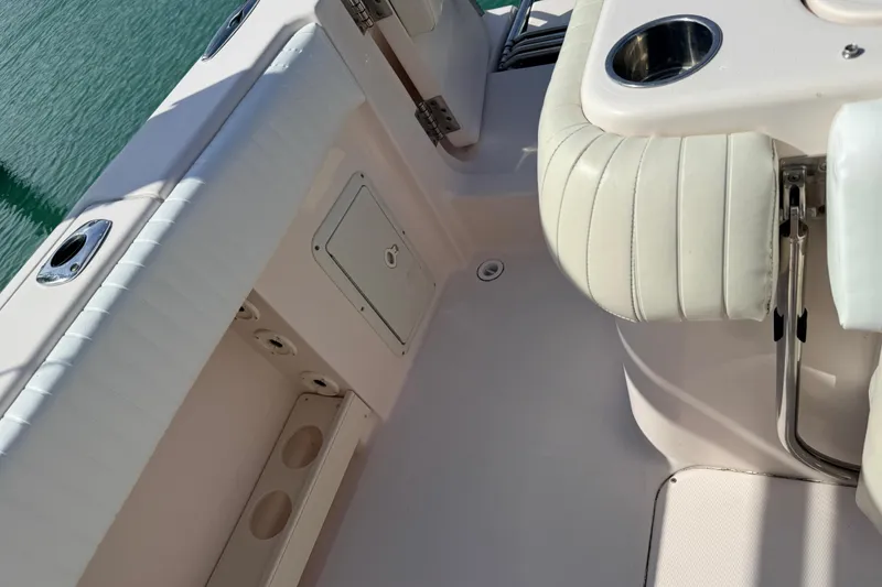 Slide: The Image of Interior view of 2013 Grady-White Canyon 306 boat, featuring seating and cup holders. - 23