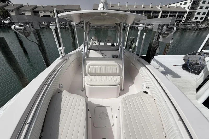 Slide: The Image of 2013 Grady-White Canyon 306 boat interior with seating and console, docked at marina. - 24