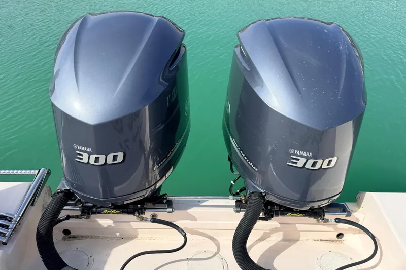 Slide: The Image of Twin Yamaha 300 engines on a 2013 Grady-White Canyon 306 boat in turquoise water. - 28