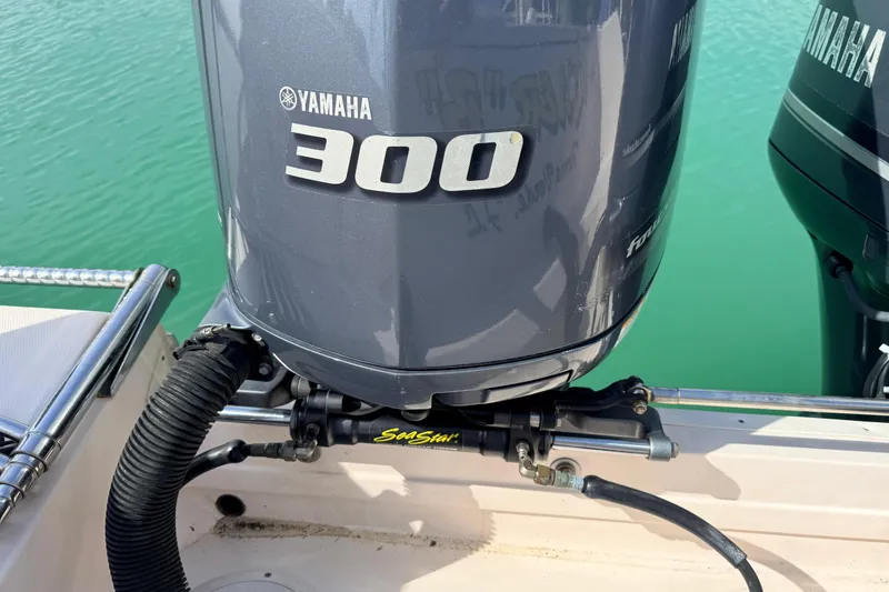 Slide: The Image of Yamaha 300 outboard motor on 2013 Grady-White Canyon 306 boat, docked in clear water. - 29