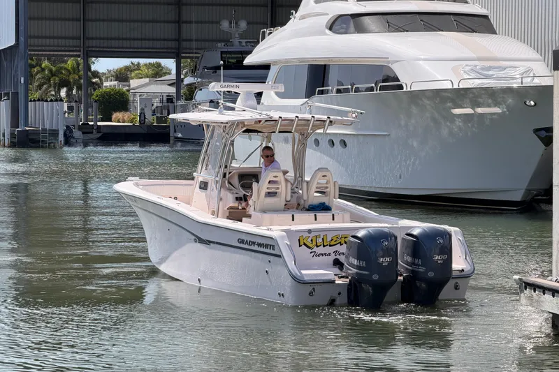 Slide: The Image of 2013 Grady-White Canyon 306 boat with twin Yamaha engines docked in marina. - 4
