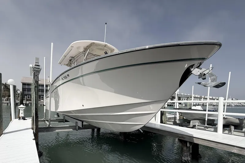 Slide: The Image of 2013 Grady-White Canyon 306 boat docked at marina, side view. - 6