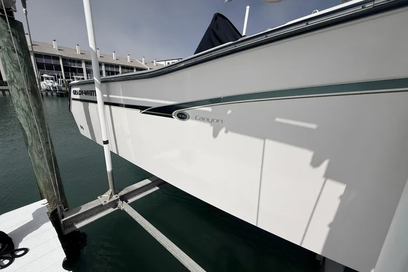 Slide: The Image of 2013 Grady-White Canyon 306 boat docked at marina, side view. - 7