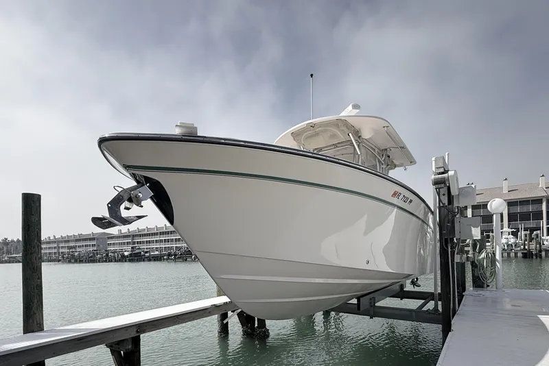 Slide: The Image of 2013 Grady-White Canyon 306 boat docked at marina, overcast sky. - 9