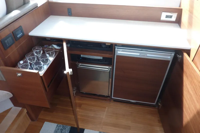 Slide: The Image of Luxurious 2019 Princess F49 yacht interior with wooden cabinetry and built-in mini fridge. - 10