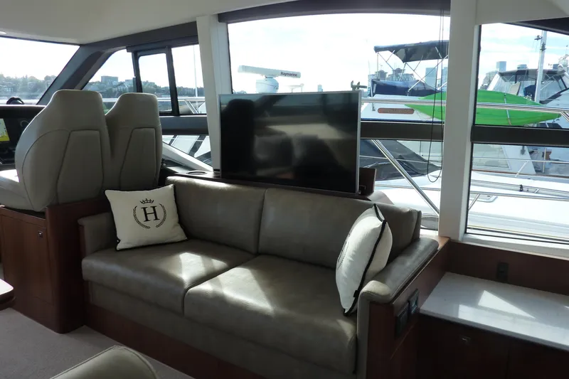 Slide: The Image of Luxurious interior of 2019 Princess F49 yacht with sofa and large windows. - 13
